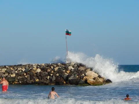 Bulgarian flag on the rocks splashed with high waves Stock Photos