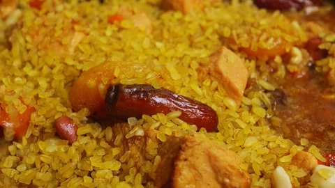 Bulgur is poured into a pan with meat and stewed dried fruits Stock Footage 244416005