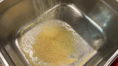 Bulgur wheat. Bulgur is poured into an empty pot Stock Footage 251879455
