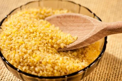 Bulgur wheat groats portion Stock Photos