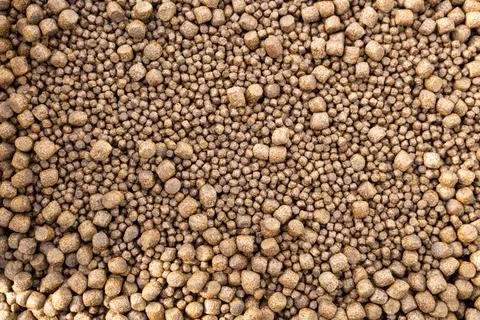 Bulk brown pellets of different sizes Stock Photos