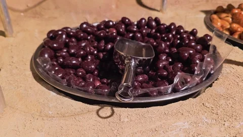 Bulk candy store footage showing coated chocolate nuts in a display tray, with Stock Footage 339848715