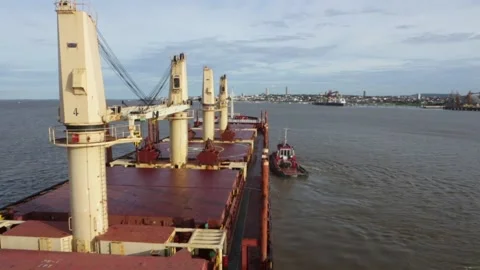Bulk cargo ship sails on the Tapajós River, pulled by a tugboat. Amazon Stock Footage 166526838