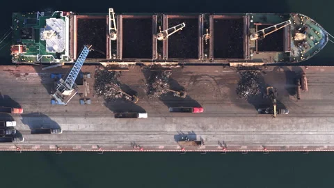 Bulk cargo ship unloading material at Port of Veracruz quay, aerial Stock Footage 345184204