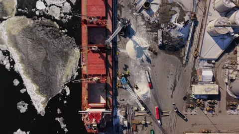 Bulk cargo transfer operation in frozen harbor canada Stock Footage 329452376