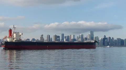 Bulk Carrier Ship Anchored in Harbour Against City Background Stock Footage 22607246