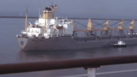 Bulk Carrier Ship Assisted By Tugboat In Mexican Harbor 1980s Stock Footage 345945230