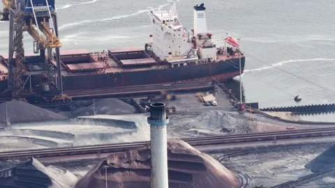 Bulk carrier ship loading cargo at industrial port terminal Stock Footage 336001887