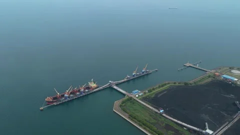 Bulk carrier ship loading coal at an indonesian power plant terminal Stock Footage 327600323