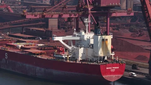Bulk carrier ship loading iron ore at an industrial port terminal Stock Footage 342751851