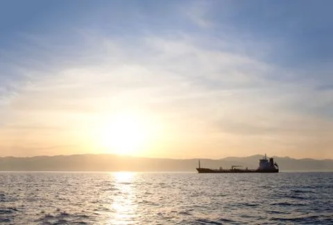 Bulk-carrier ship at sunset Stock Photos