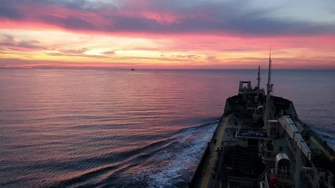 Bulk carrier silhouette sails on deep blue river at sunset Stock Footage 113189370