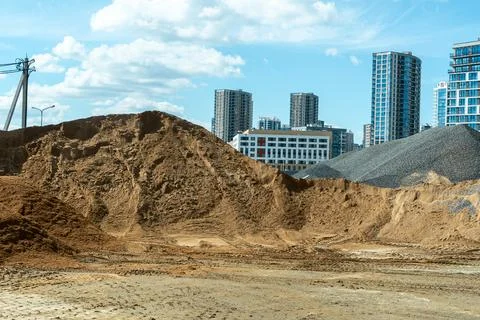 Bulk construction materials sand and gravel heaps at development site again.. Stock Photos