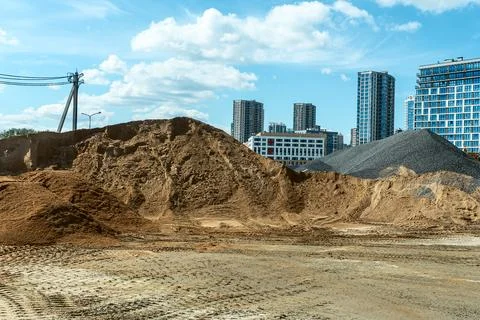 Bulk construction materials sand and gravel heaps at development site again.. Stock Photos
