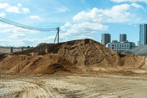 Bulk construction materials sand and gravel heaps at development site again.. Stock Photos