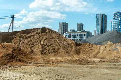Bulk construction materials sand and gravel heaps at development site again.. Stock Photos