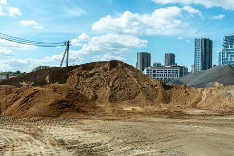 Bulk construction materials sand and gravel heaps at development site again.. Stock Photos