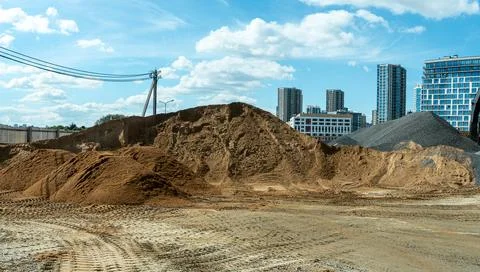 Bulk construction materials sand and gravel heaps at development site again.. Stock Photos