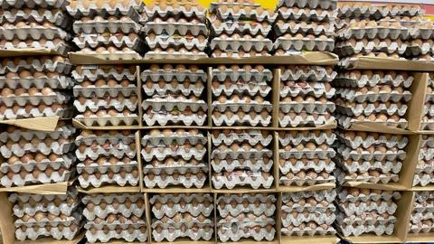 Bulk quantity of brown chicken eggs being sold in a grocery store Foto stock