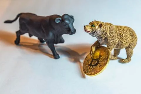 Bull and Bear Fight over Bitcoin Stock Photos