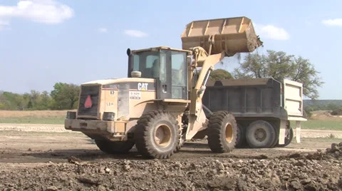Bull Dozer dropping dirt into truck Stock Footage 39637053