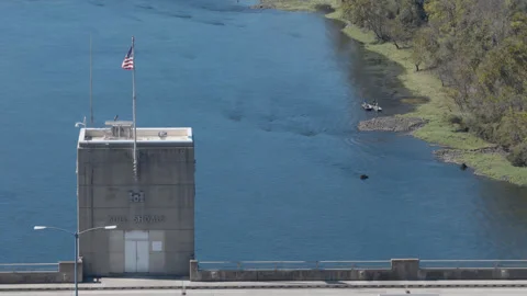 Bull Shoals Dam Control Tower with American Flag Above Blue River Stock Footage 344215972