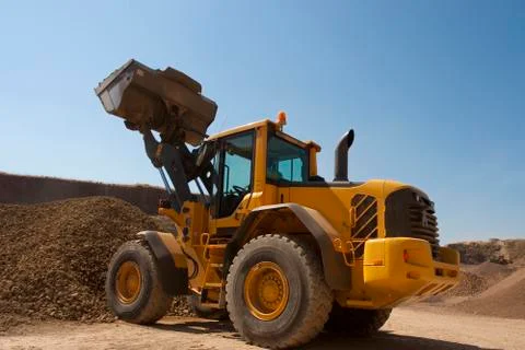 Bulldozer in action in the quarry Stock Photos