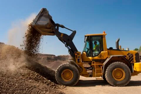 Bulldozer in action in the quarry Stock Photos