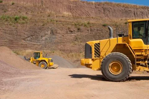 Bulldozer in action in the quarry Stock Photos