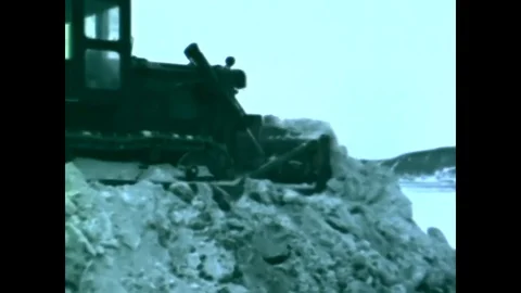 A bulldozer, aircraft, icebreaker ship and an atomic reactor are shown at Stock Footage
