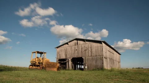 Bulldozer and Barn Time lapse with Puffy Clouds Stock-Footage 67013287