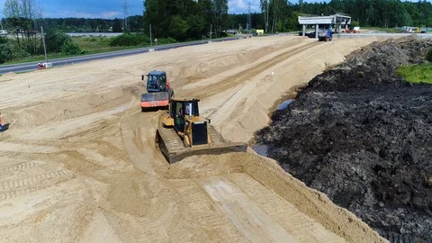 Bulldozer and roll leveled sand. New road construction transport infrastructure Stock Footage 129101895