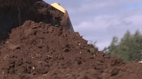 Bulldozer blade puching large quantity of soil Stock Footage 52778282