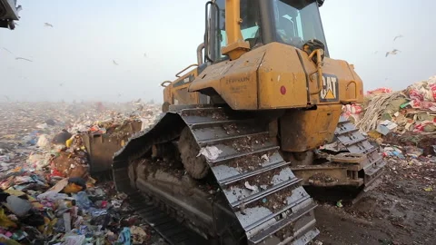 Bulldozer cleans up garbage at the landfill Stock Footage 229760372