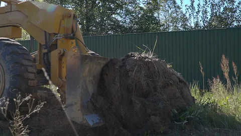 A bulldozer clears the area for road construction. Stock Footage 288224785