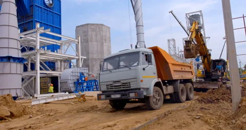 The bulldozer does earthworks and loads the drive up truck Stock Footage 161992561