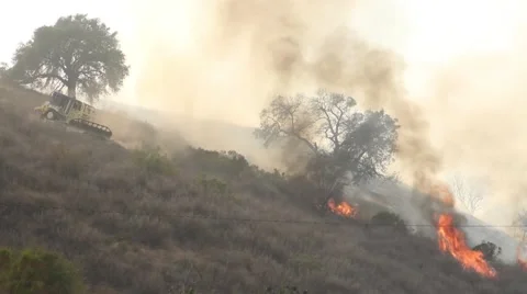 Bulldozer fighting fire Stock Footage 49560314