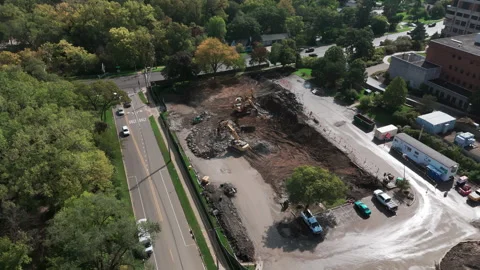 A bulldozer levels a plot of land for construction development area. Wide aerial Stock Footage 256322690