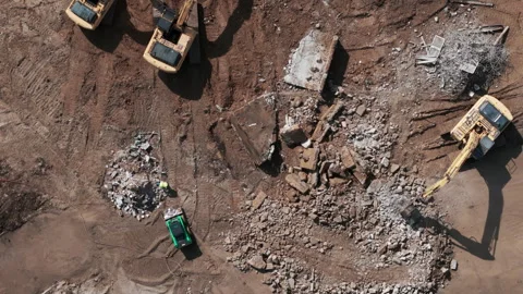 A bulldozer levels a plot of land for construction development. Top down aerial Stock Footage 256735905