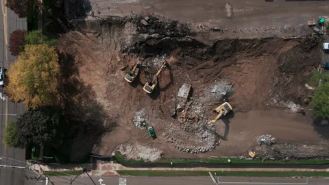 A bulldozer levels a plot of land for construction development. Top down wide Vídeos de archivo 256736225