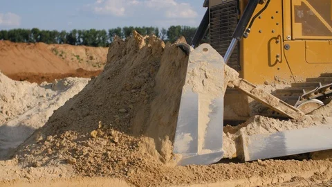 Bulldozer machine moving sand in sand quarry. Mining equipment at quarry Stock Footage 114378342