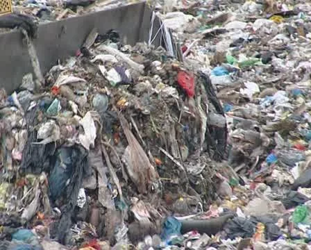 Bulldozer move trash in dump and homeless people walking around. Stock Footage 10727881