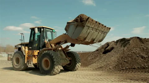 Bulldozer pouring sand on the pile, tracking shot, sand separation, construction Stock Footage