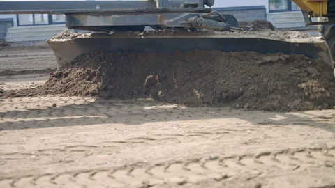 Bulldozer preparing construction site, moving dirt and spreading sand to build Stock Footage 270213063
