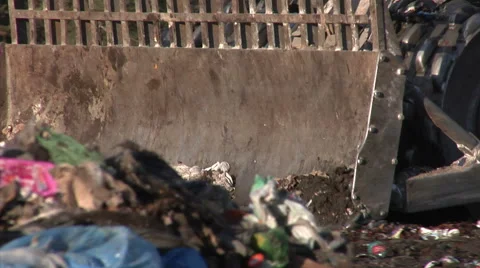 Bulldozer pulling trash on a landfill site. Close up and zoom out. Stock Footage 61759286