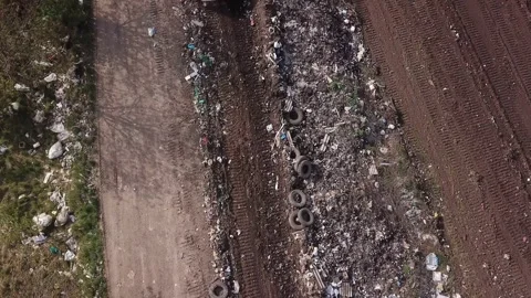 Bulldozer pushes garbage onto one pile Stock Footage 138634720