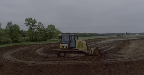 Bulldozer Pushing Dirt Around a Corner Filmed from a Drone Stock Footage 81755972