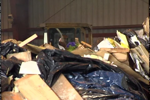 BULLDOZER PUSHING GARBAGE Stock Footage 1052644