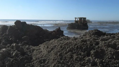Bulldozer pushing sand on beach Video stock 106849533