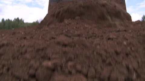 Bulldozer pushing soil on camera and lifting blade Stock Footage 52778103